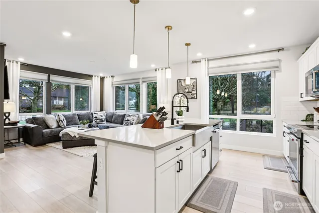 a large white kitchen with a large window