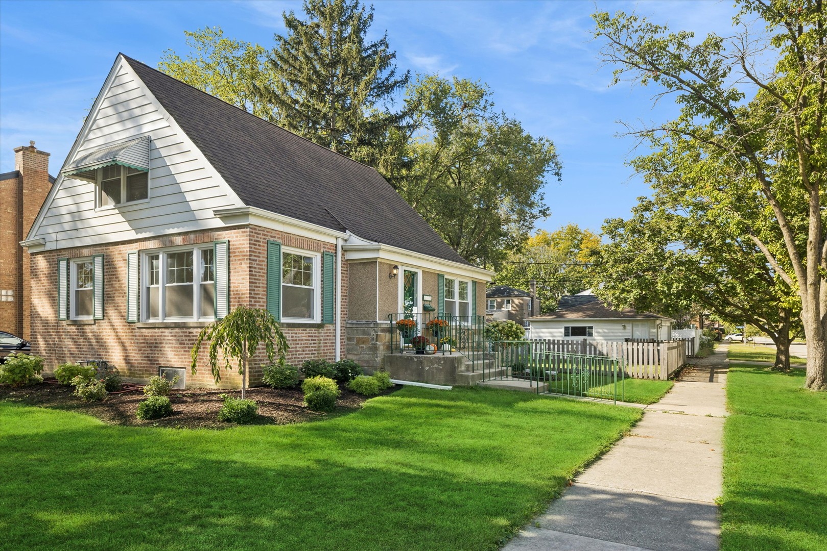 a front view of house with yard and outdoor seating