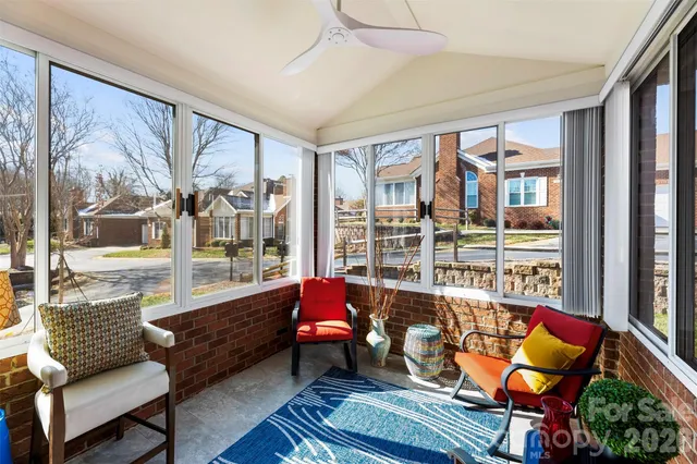 a living room with furniture and a floor to ceiling window