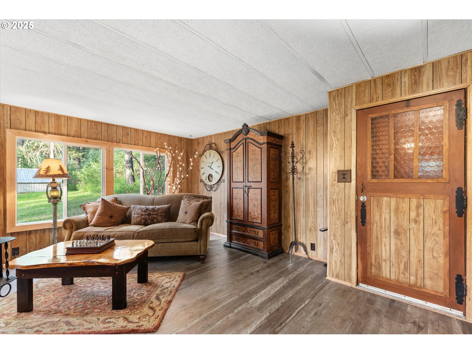 74576 Thompson Road Elgin, OR 97827 - Photo 25 of 47 a living room with furniture a large window and wooden floor
