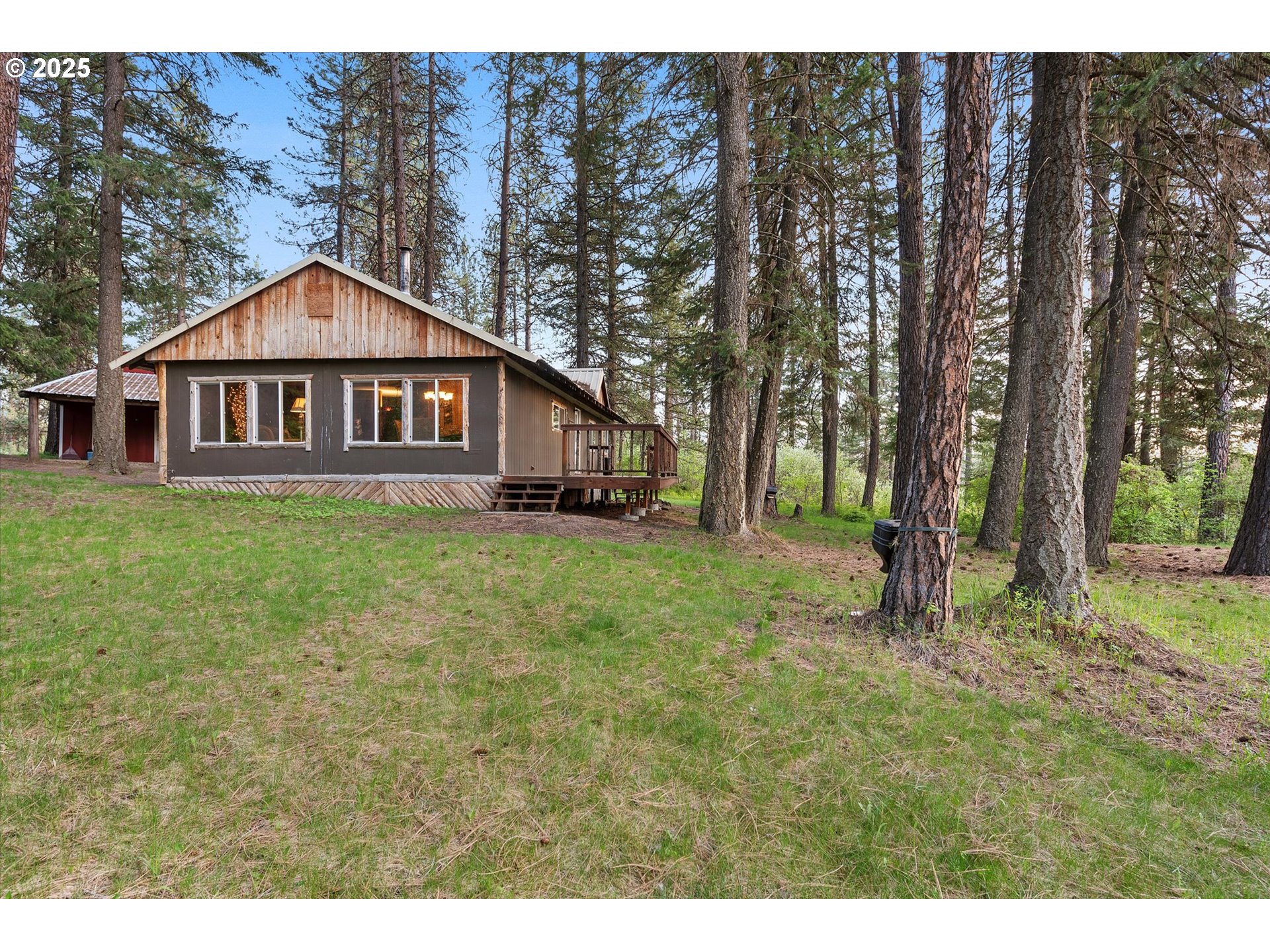 74576 Thompson Road Elgin, OR 97827 - Photo 5 of 47 a view of a house with a yard and large trees