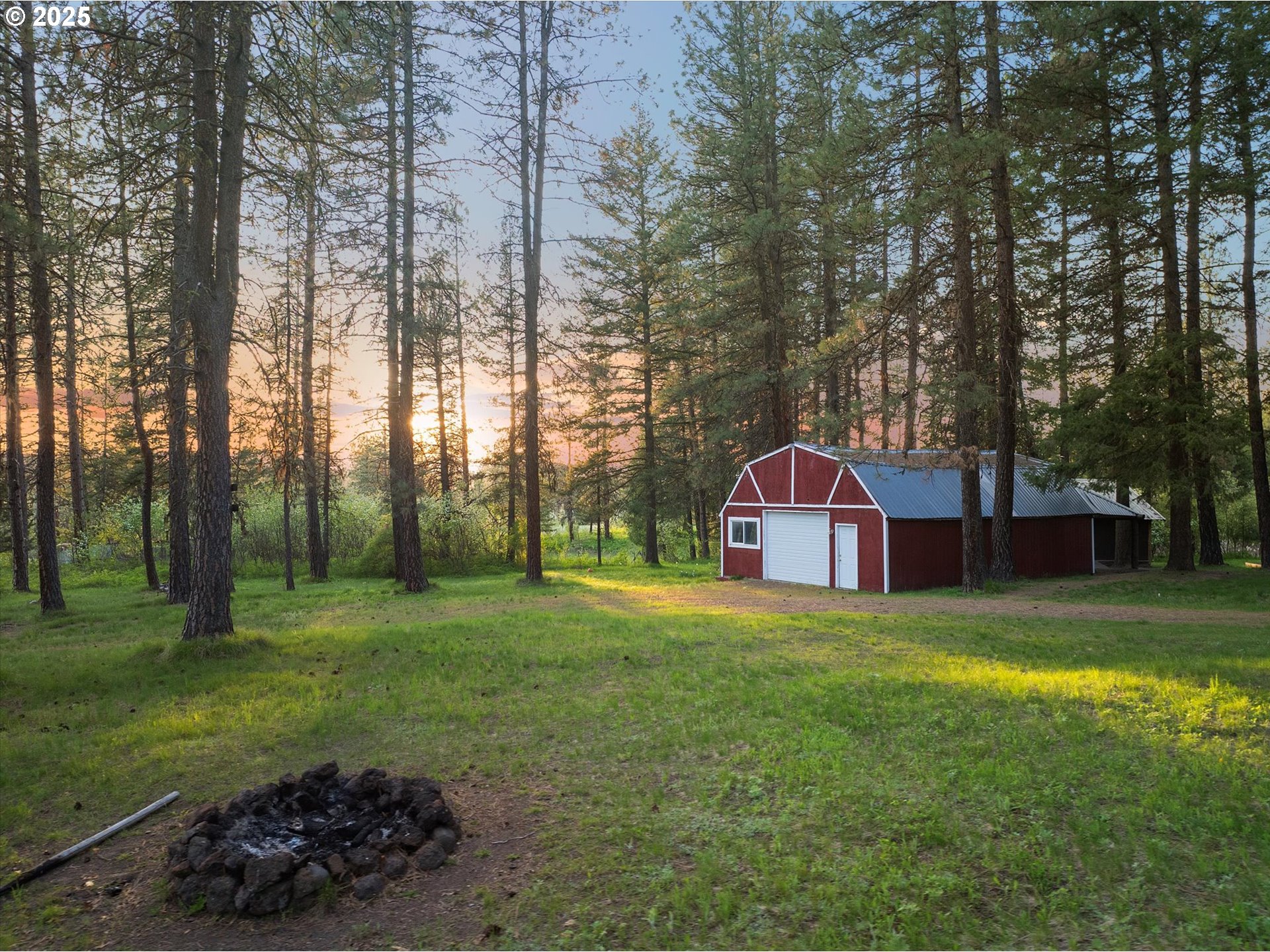 74576 Thompson Road Elgin, OR 97827 - Photo 6 of 47 a view of a big yard with a fountain and large trees