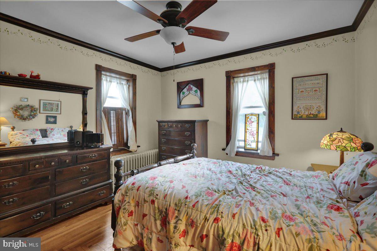758 Fritztown Road Reading, PA 19608 - Photo 18 of 27 a bedroom with a bed and wooden floor