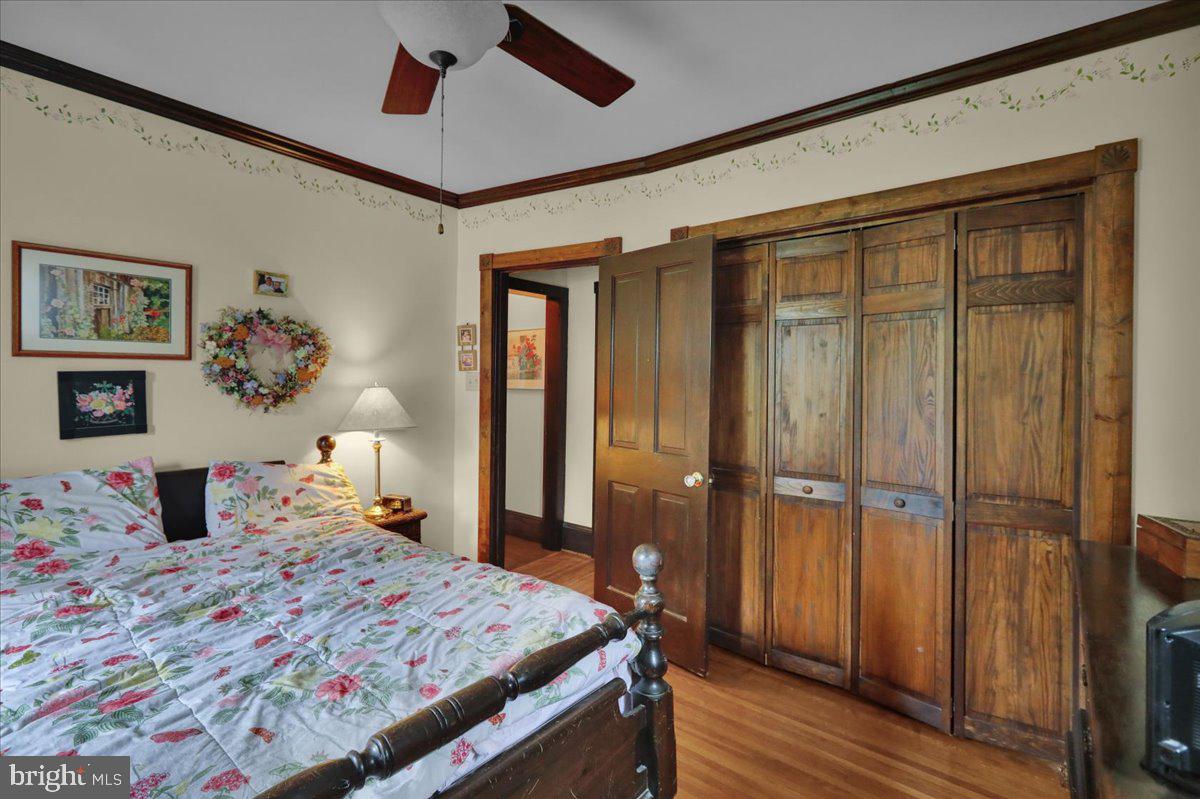 758 Fritztown Road Reading, PA 19608 - Photo 19 of 27 a bedroom with a bed and a chandelier