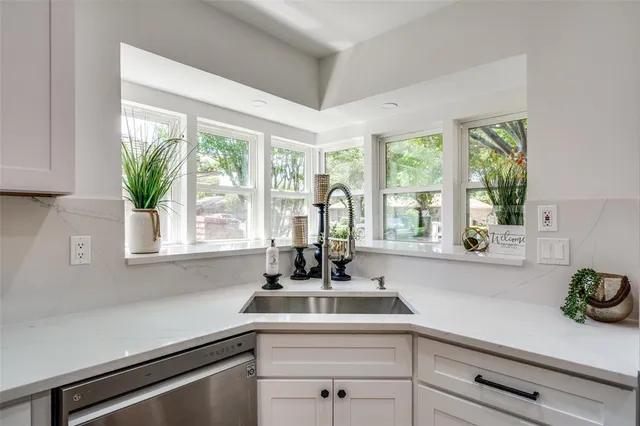 a kitchen with a sink and large window