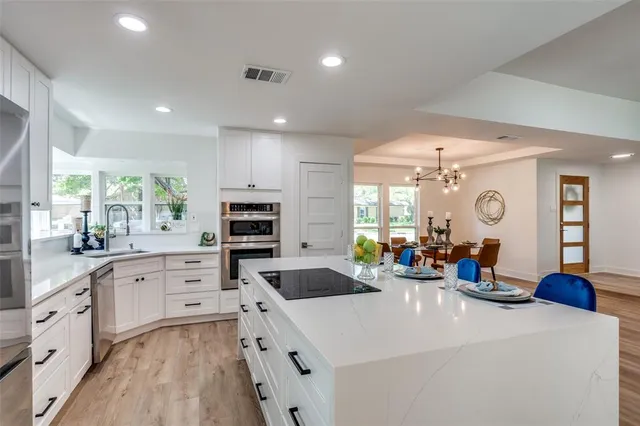 a kitchen with sink a stove and cabinets