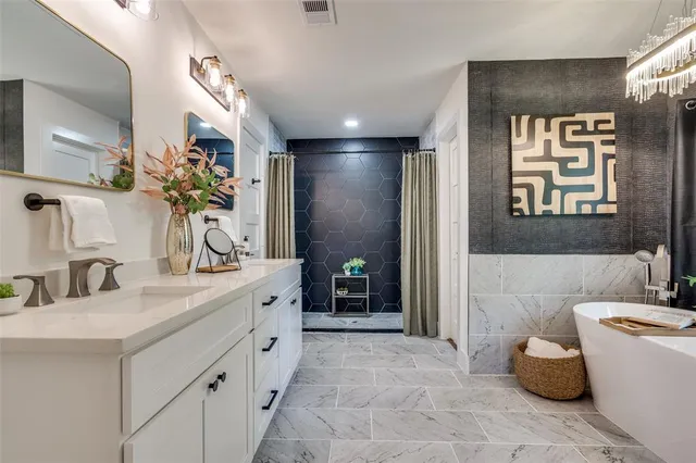 a bathroom with a double vanity sink a mirror and a bathtub