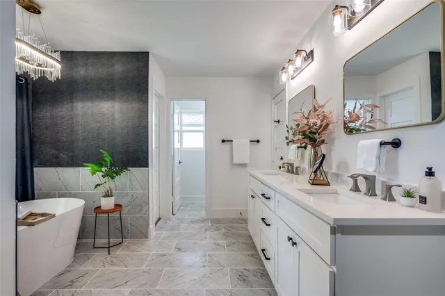 a spacious bathroom with a double vanity sink and a mirror