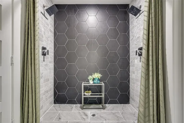 a bathroom with a glass door shower and a sink