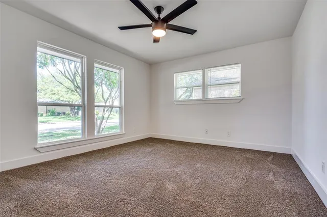 a view of a livingroom with a ceiling fan and window