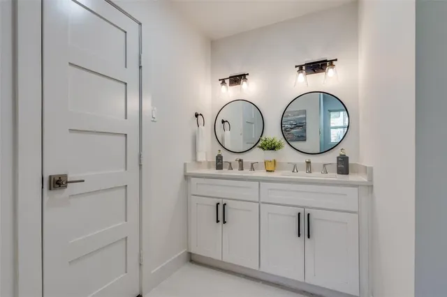 a view of bathroom with dual sinks