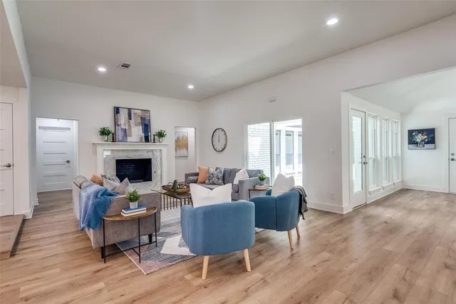 a living room with furniture a fireplace and a table