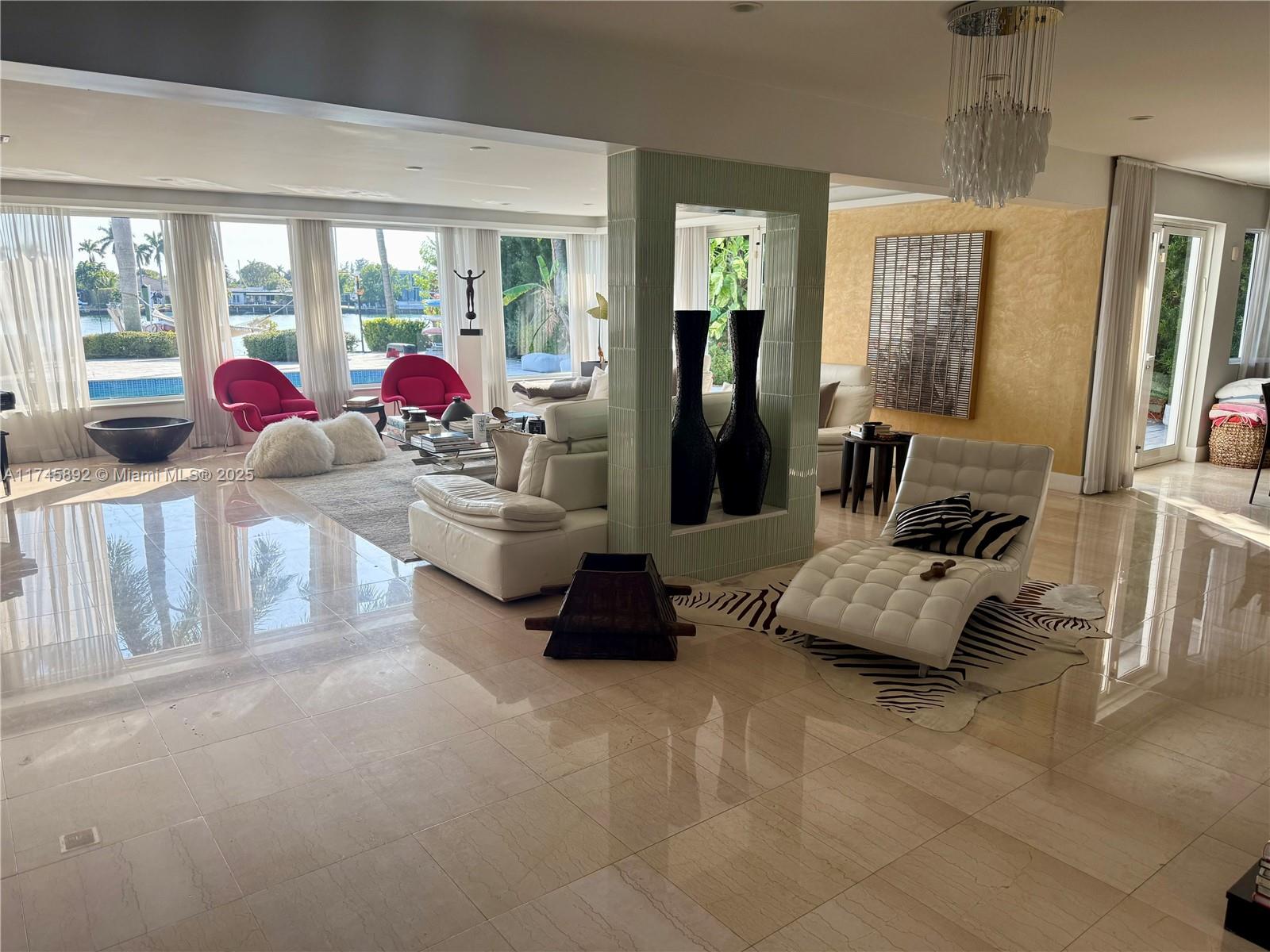 1670 Daytonia Road Miami Beach, FL 33141 - Photo 12 of 24 a living room with furniture and a large window