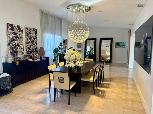 a view of a dining room with furniture and chandelier