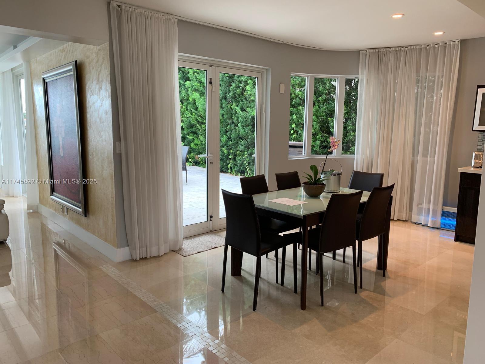 1670 Daytonia Road Miami Beach, FL 33141 - Photo 16 of 24 a dining room with furniture and large windows