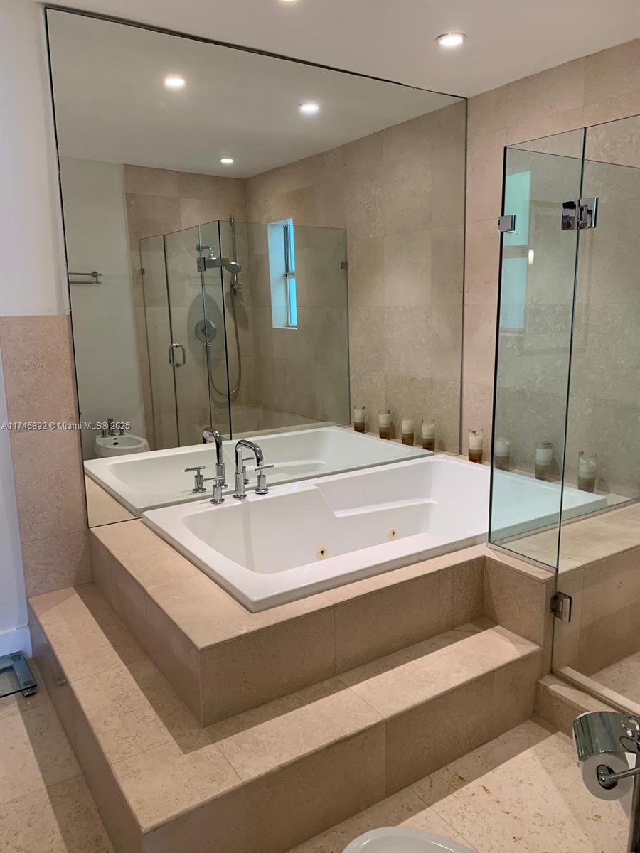 1670 Daytonia Road Miami Beach, FL 33141 - Photo 22 of 24 a spacious bathroom with a bathtub and a sink