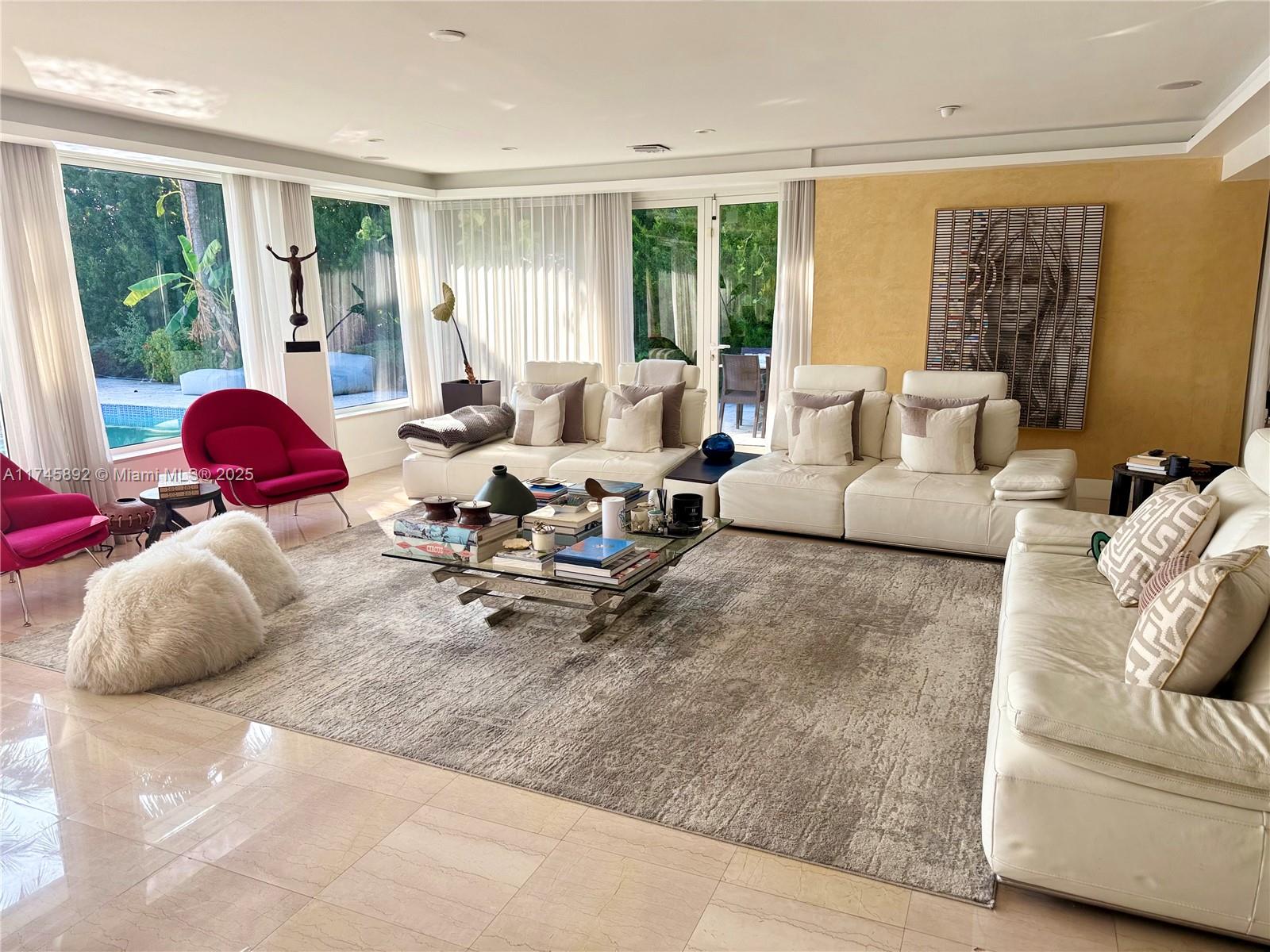 1670 Daytonia Road Miami Beach, FL 33141 - Photo 4 of 24 a living room with furniture and large windows