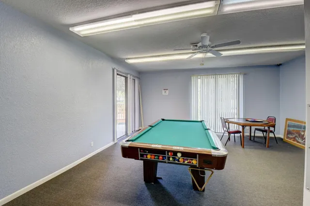 a room with furniture and pool table