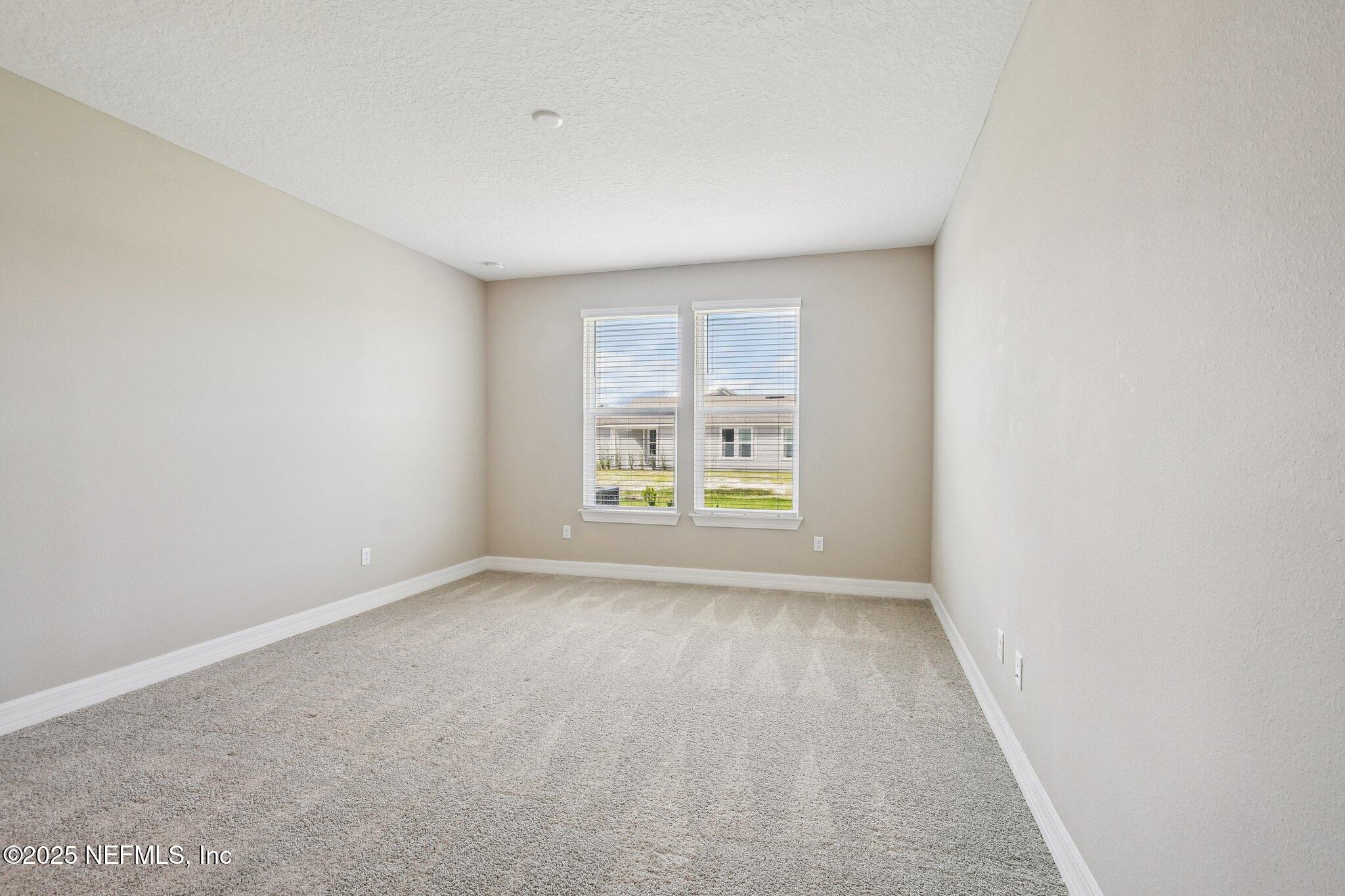 729 Continuum Loop Yulee, FL 32097 - Photo 15 of 31 an empty room with windows