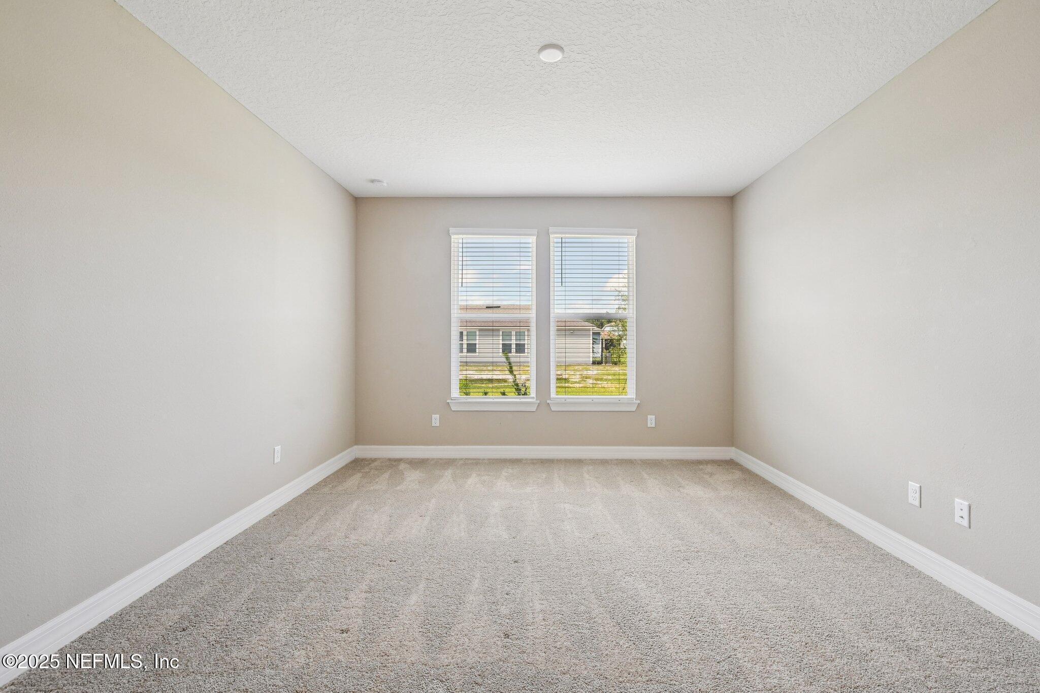 729 Continuum Loop Yulee, FL 32097 - Photo 18 of 31 an empty room with windows
