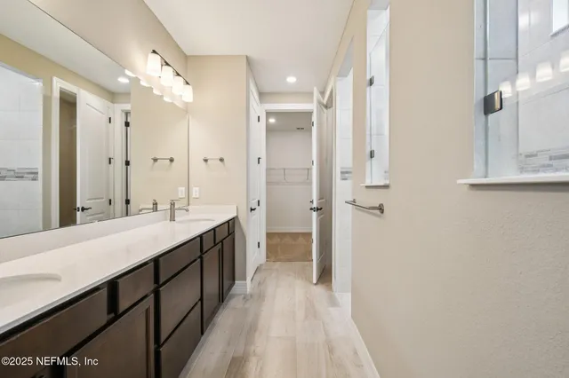 a bathroom with a double vanity sink mirror double and shower