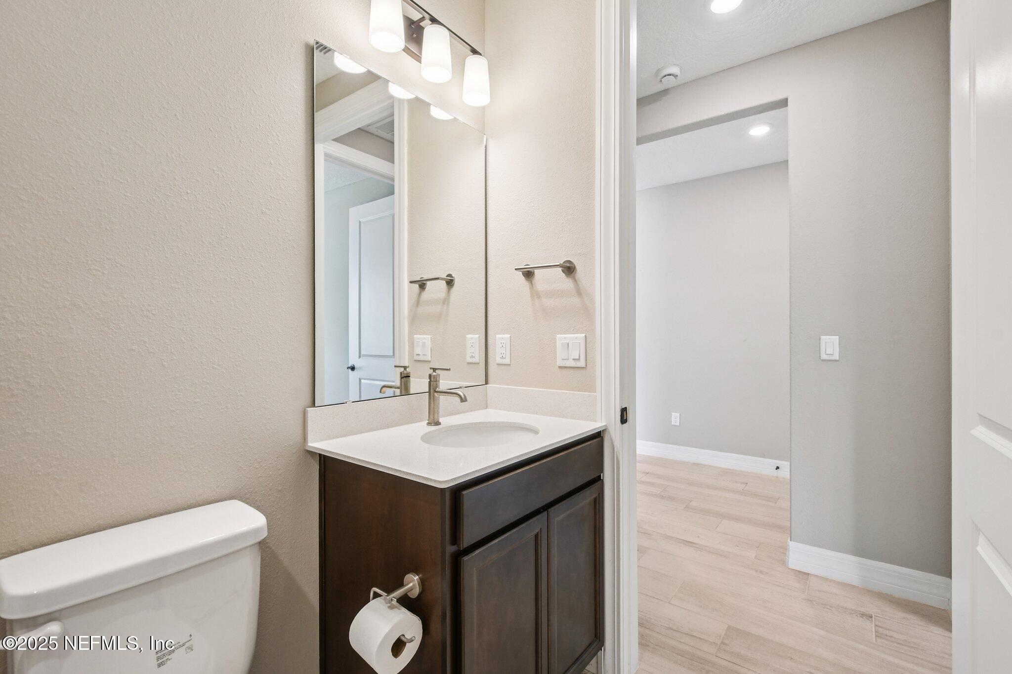 729 Continuum Loop Yulee, FL 32097 - Photo 22 of 31 a bathroom with a toilet sink and mirror