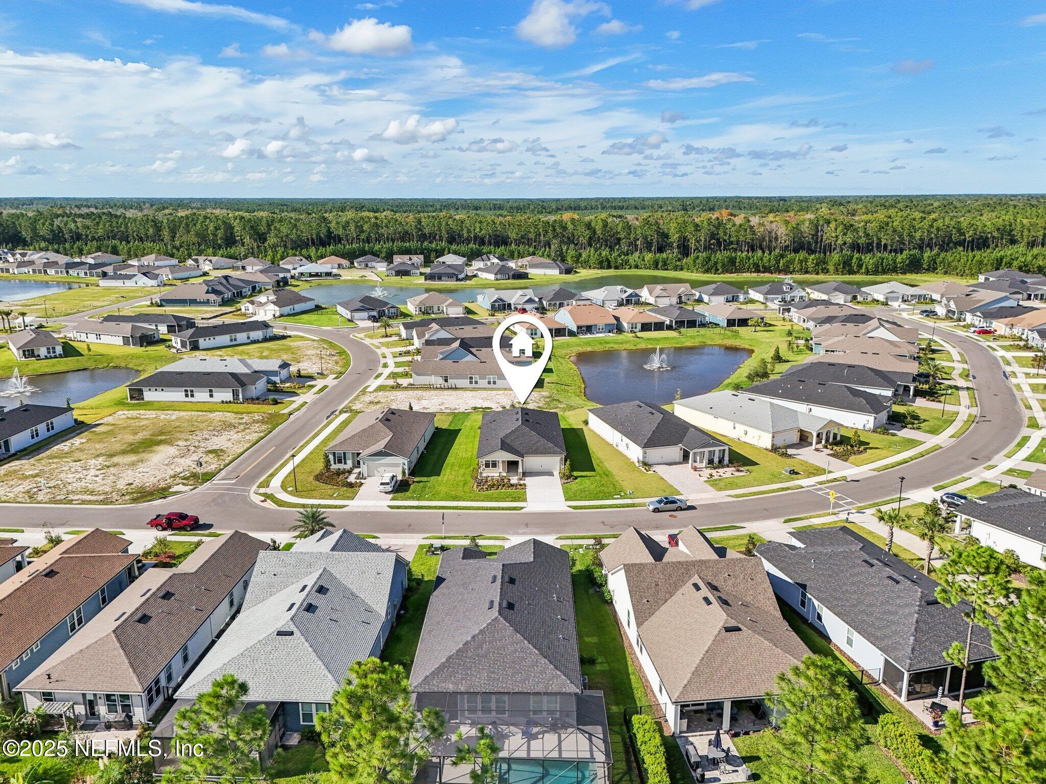 729 Continuum Loop Yulee, FL 32097 - Photo 30 of 31 an aerial view of residential houses with outdoor space