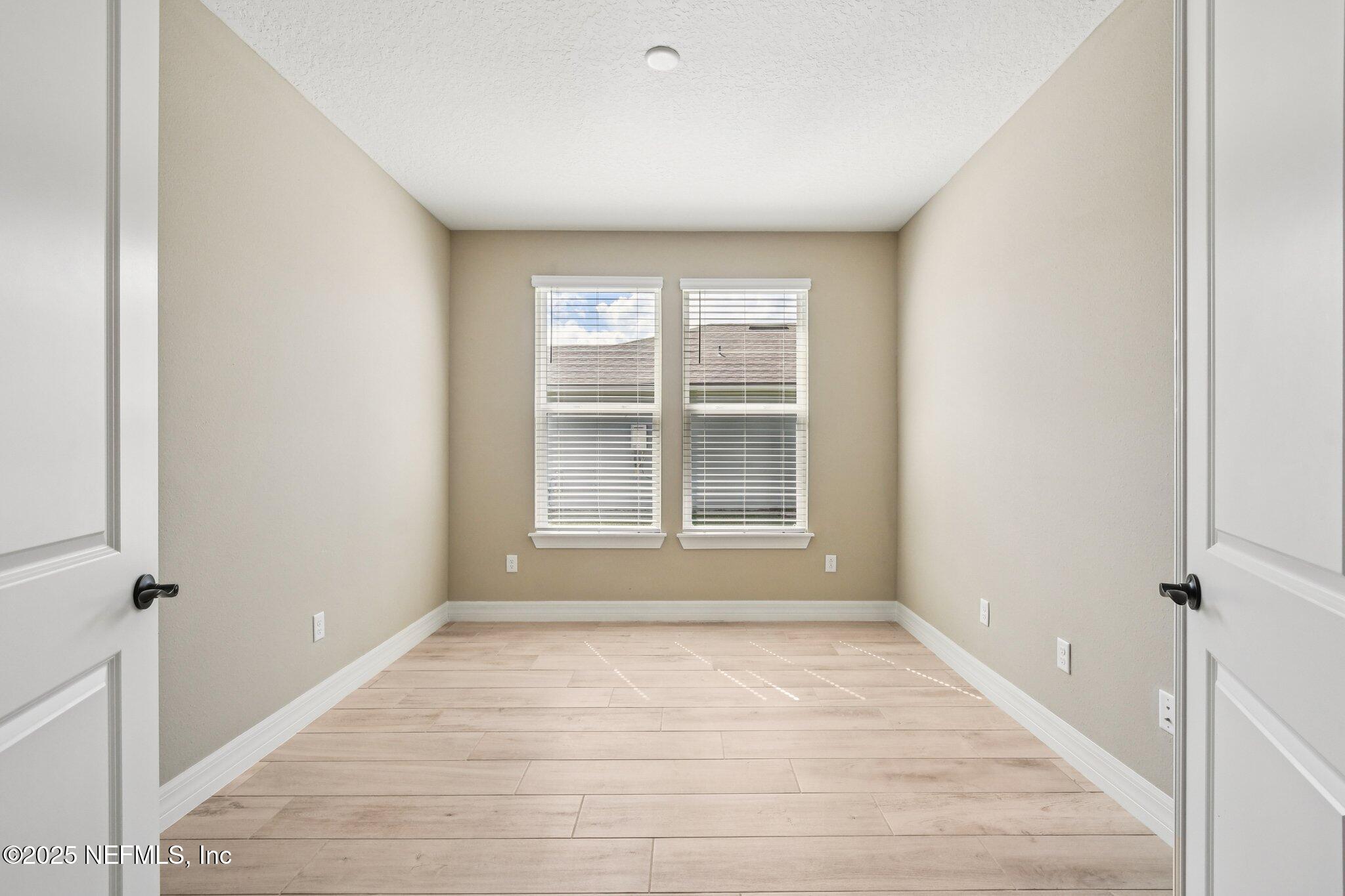 729 Continuum Loop Yulee, FL 32097 - Photo 4 of 31 a view of empty room with wooden floor and fan