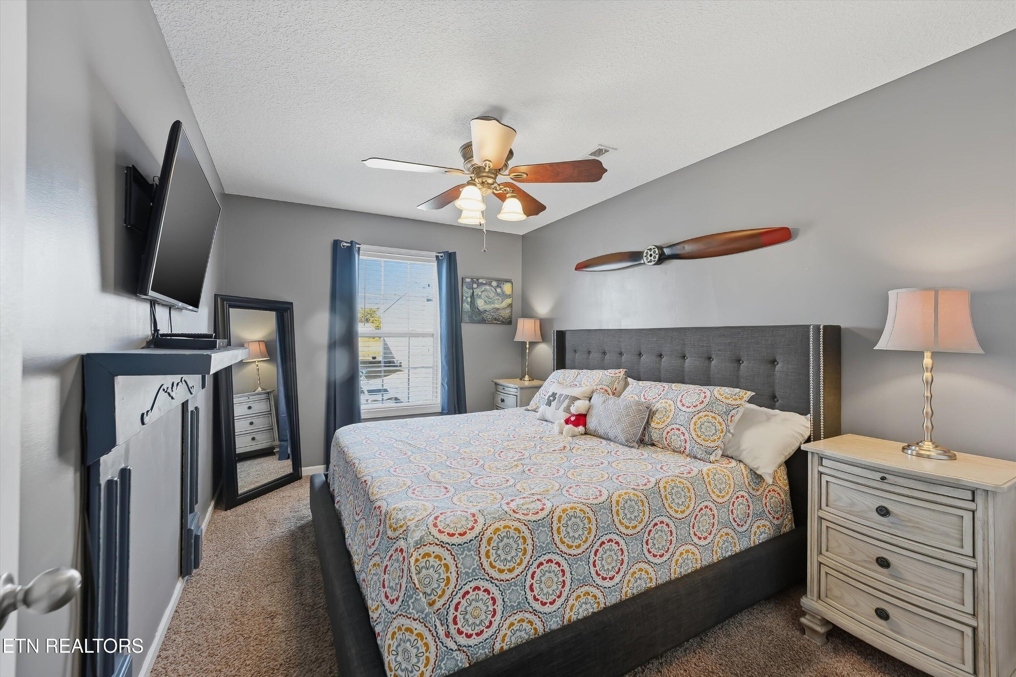 8508 Bowsong Lane Powell, TN 37849 - Photo 16 of 28 a bedroom with a large bed and a flat tv screen on a dresser