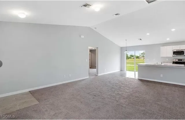 a view of large kitchen with a sink and a window