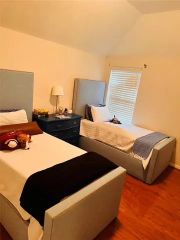 a bed sitting in a bedroom next to a lamp