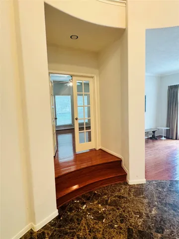a view of room with wooden floor
