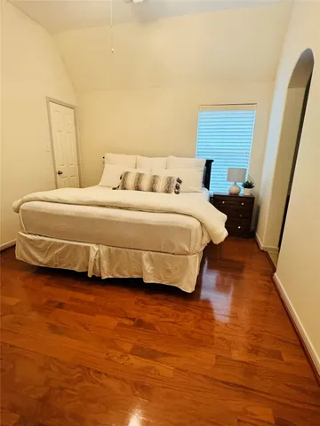 a bedroom with a bed and a large window