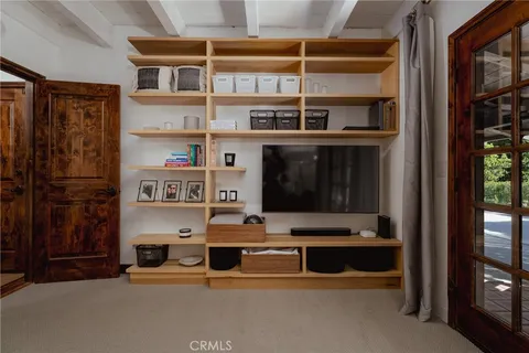 a living room with furniture cabinets and a window