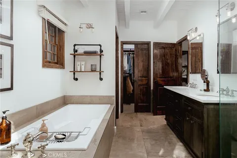 a bathroom with a tub sink and mirror