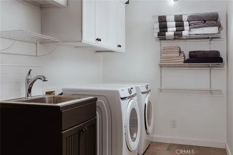 a utility room with stainless steel appliances washer and dryer