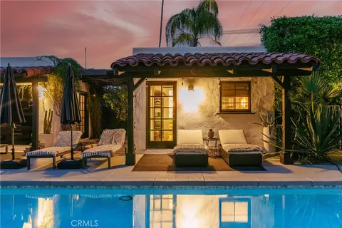 a view of swimming pool with outdoor seating