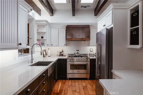 a kitchen with stainless steel appliances a sink stove and refrigerator