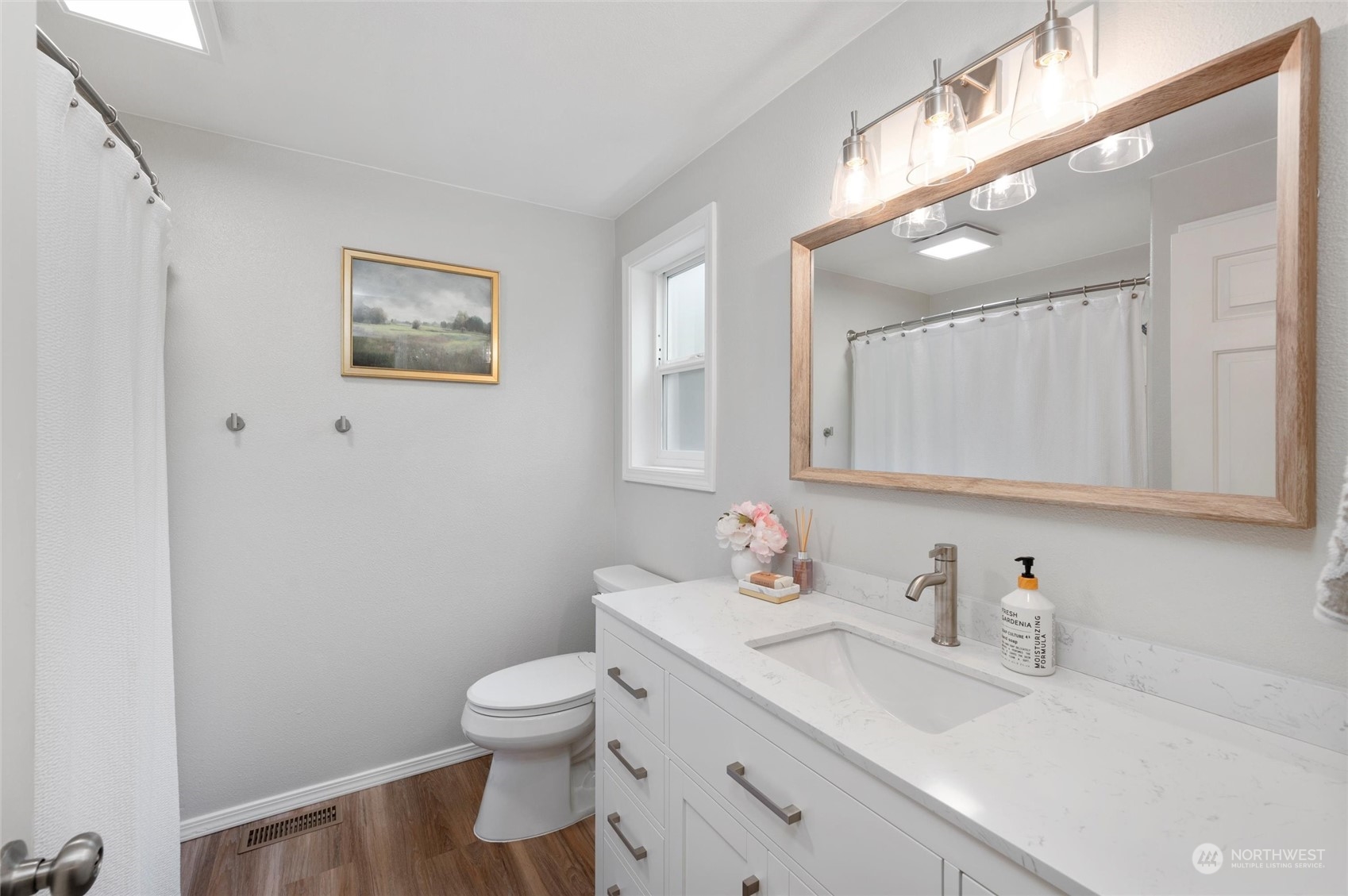 5052 Noon Road Bellingham, WA 98226 - Photo 27 of 40 a bathroom with a toilet a sink and mirror