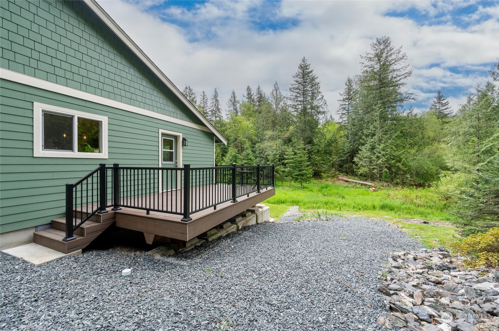 5052 Noon Road Bellingham, WA 98226 - Photo 4 of 40 a backyard of a house with a garden and deck