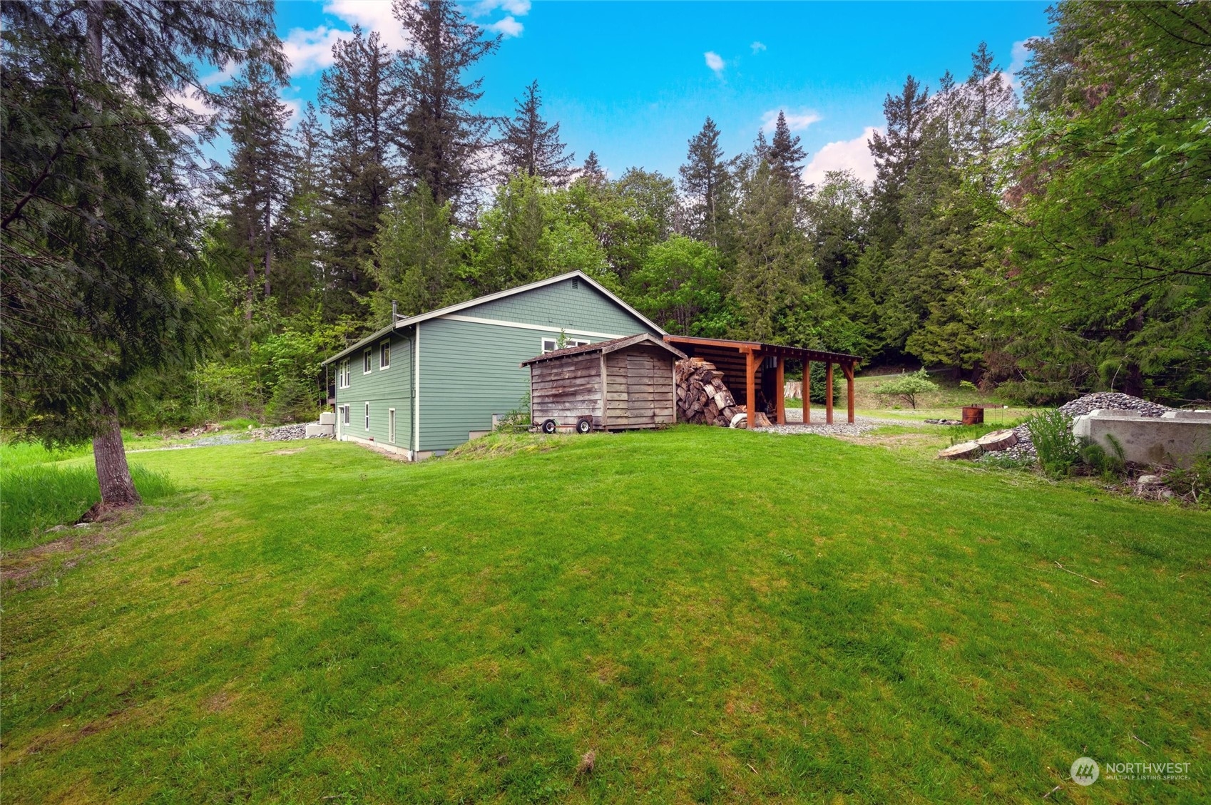 5052 Noon Road Bellingham, WA 98226 - Photo 7 of 40 a view of a house with a big yard and large trees