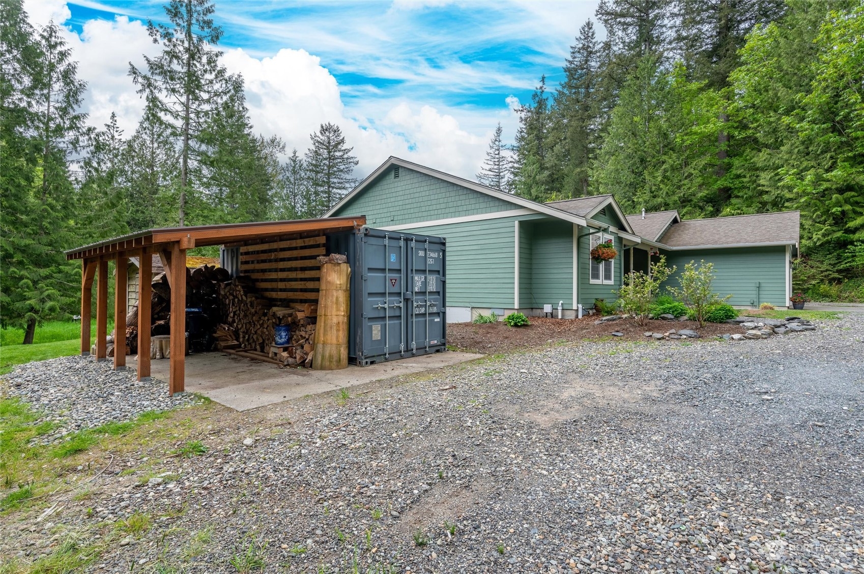 5052 Noon Road Bellingham, WA 98226 - Photo 8 of 40 a view of a house with large trees and wooden fence