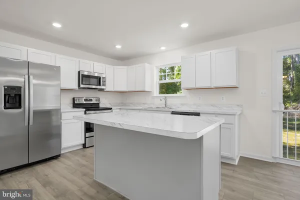 a kitchen with white cabinets and white appliances