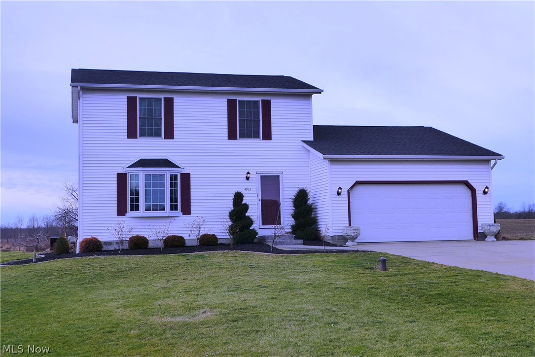 4912 South County Line Road Madison, OH 44057 - Photo 23 of 23 Professionally landscaped front and side of house. Its hard to see but there are bush roses which bloom from mid summer through the fall! Exterior lights both on front of house and both sides of garage