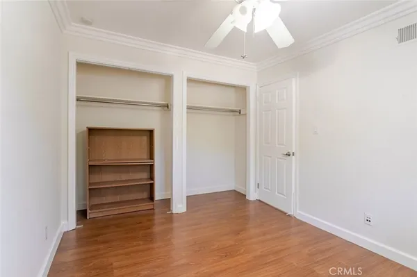 a view of an empty room with a ceiling fan