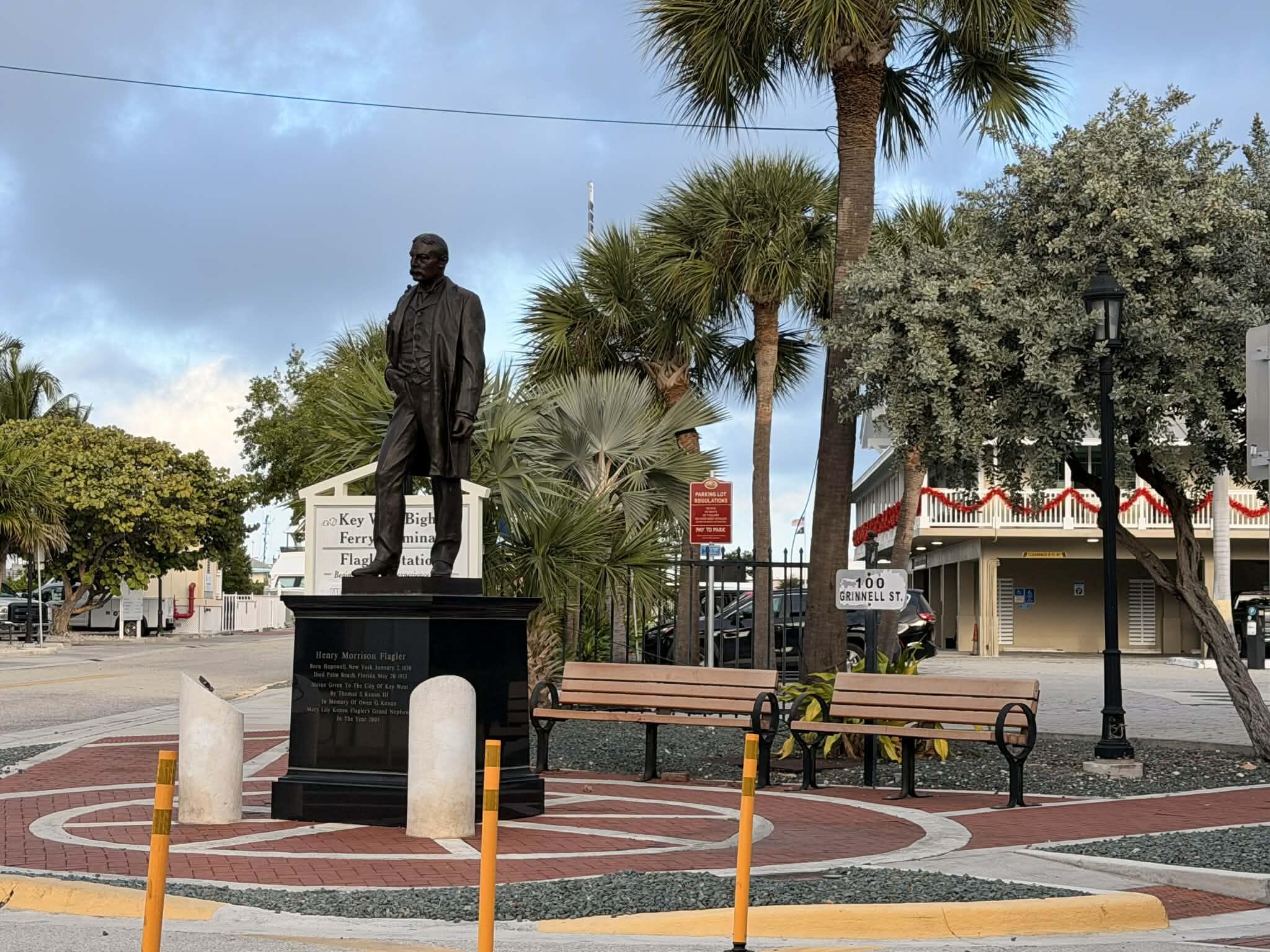 301 Grinnell Street, Unit A401 Key West, FL 33040 - Photo 4 of 8 a front view of a patio with table and chairs potted plants and palm tree