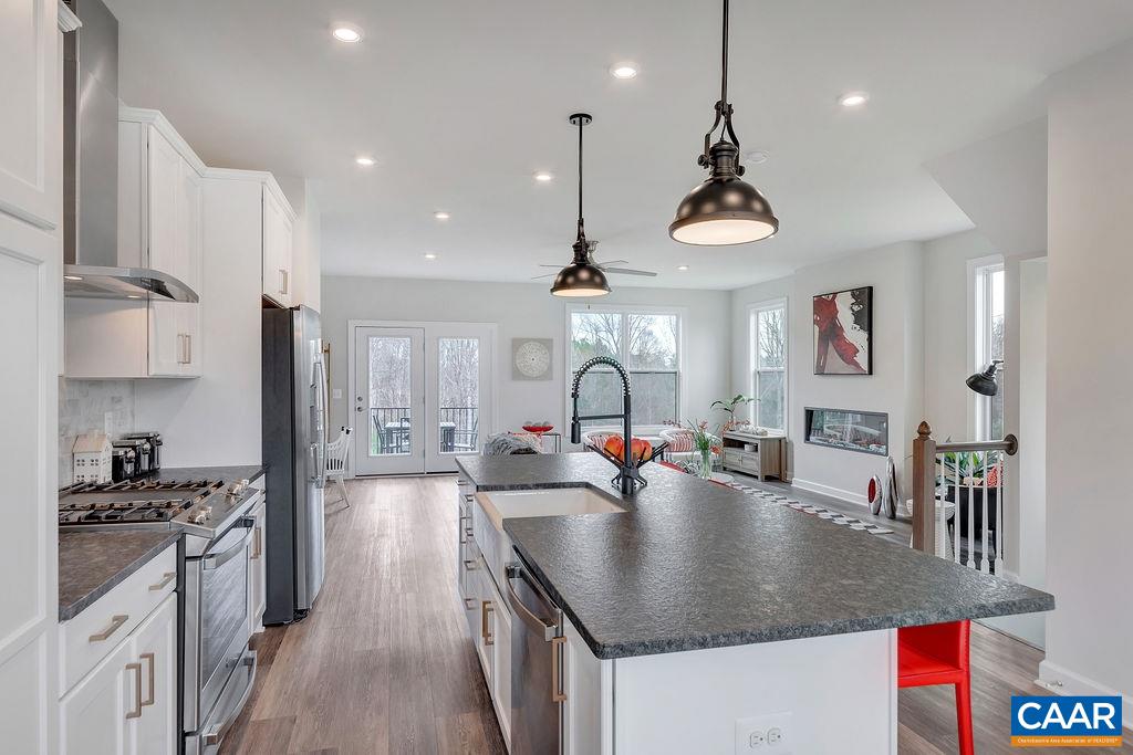 2245 Fowler Street Charlottesville, VA 22901 - Photo 12 of 27 a kitchen with stainless steel appliances granite countertop a sink dishwasher and a stove with wooden floor