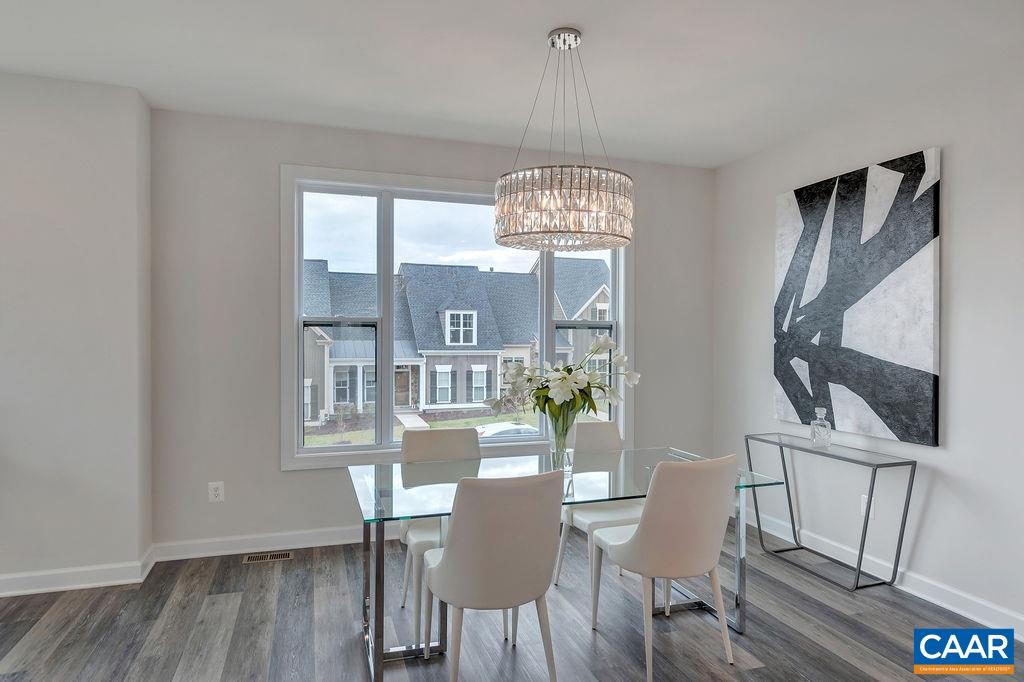 2245 Fowler Street Charlottesville, VA 22901 - Photo 14 of 27 a view of a dining room with furniture a chandelier and wooden floor