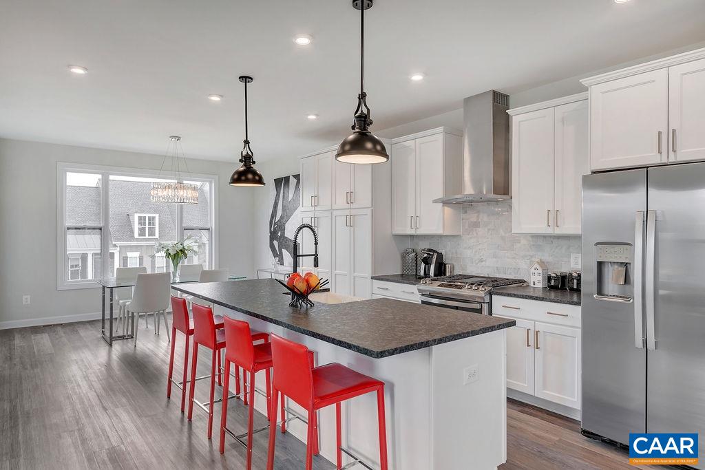 2245 Fowler Street Charlottesville, VA 22901 - Photo 10 of 27 a kitchen with stainless steel appliances granite countertop a sink a stove a refrigerator and island with wooden floor