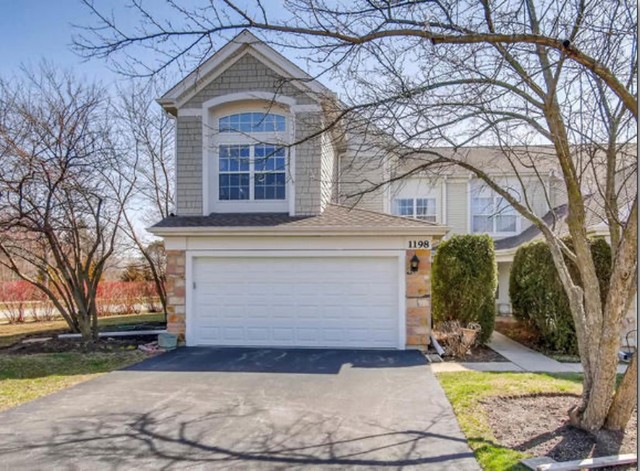 1198 Bristol Lane Buffalo Grove, IL 60089 - Photo 1 of 24 a front view of a house with garden